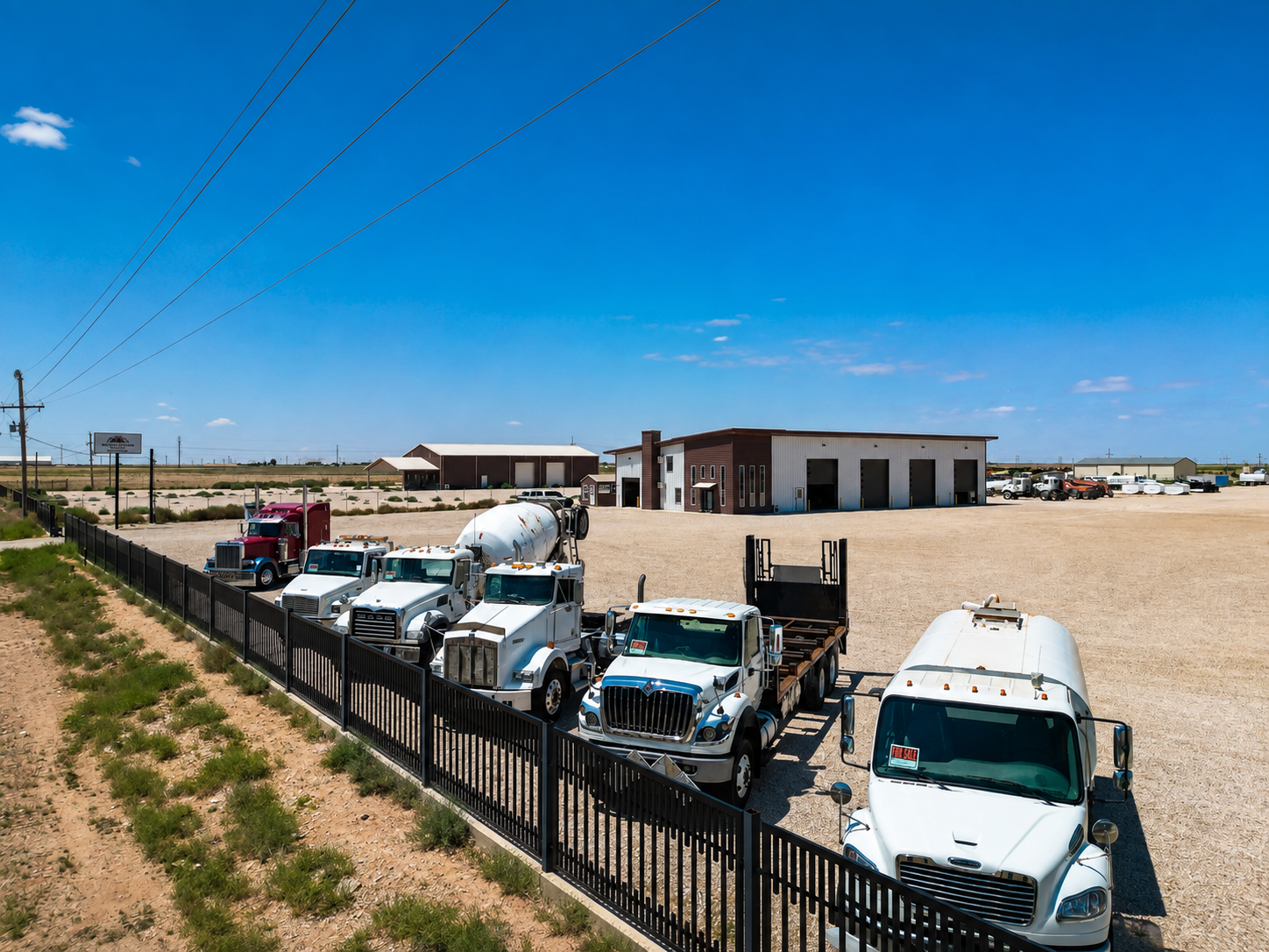 A&S Froese Truck Sales lot in Seminole, TX with water trucks, mixers and flatbeds lined up for sale